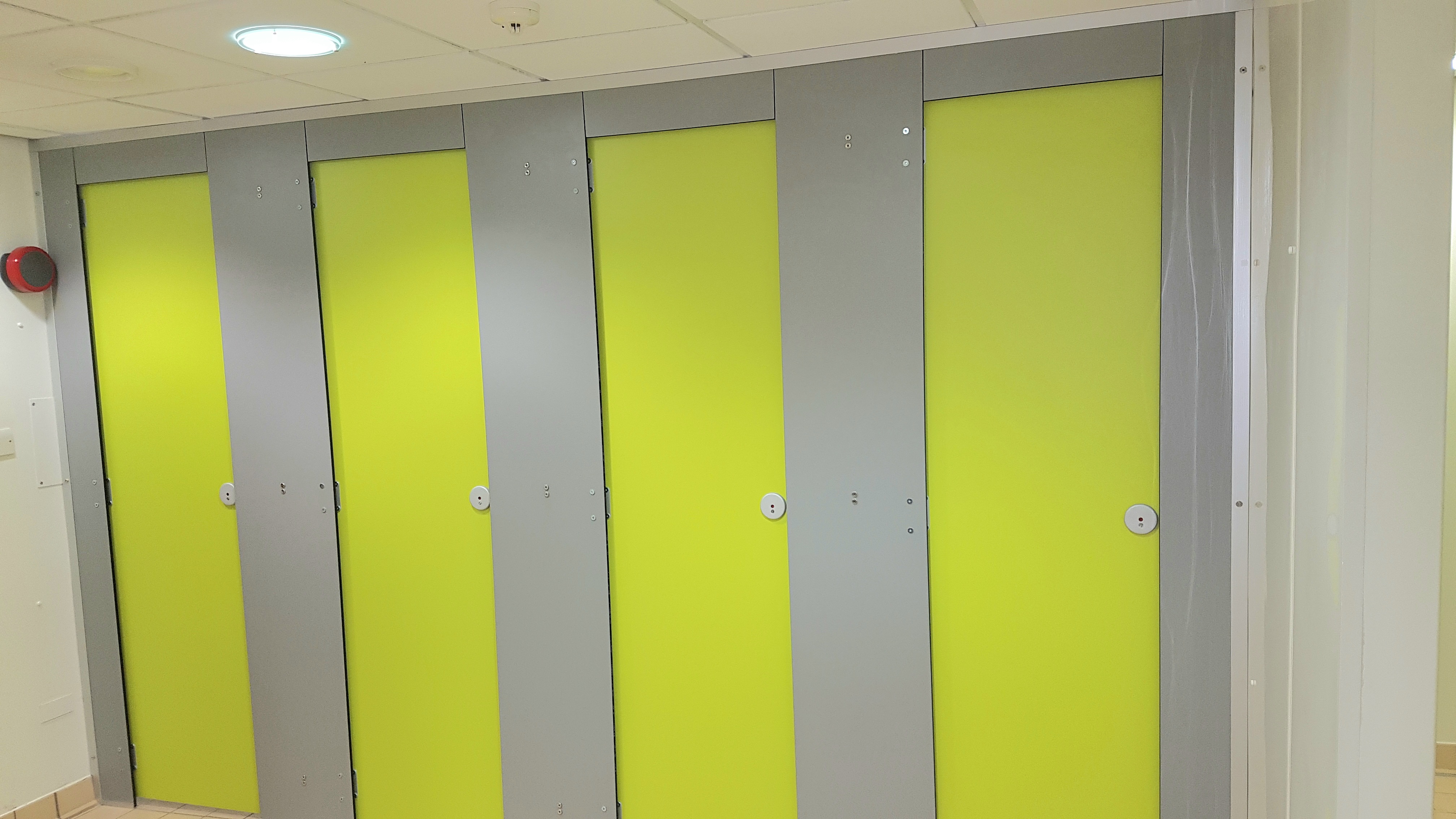 Bright green changing room, designed and installed by Skobex Washrooms